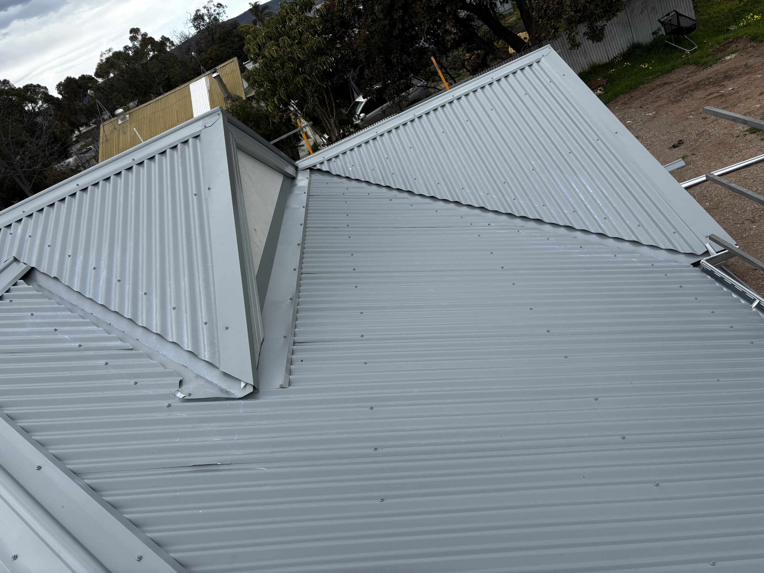 Metal roof with new ridge and hip flashings